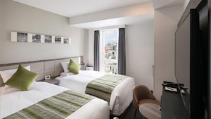 A hotel room with two beds, a television, a chair, and a window with curtains. - Hotel Mystays Nagoya Nishiki (Nagoya)
