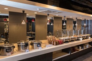 A buffet area with various food containers and a self-service setup. - Hotel Mystays Nagoya Nishiki (Nagoya)