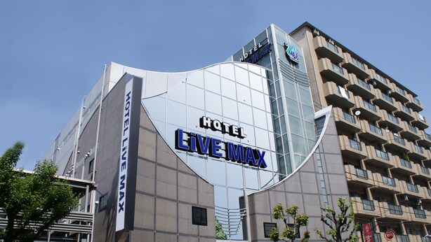 A modern hotel building with the name "HOTEL LIVE MAX" prominently displayed on its facade. - HOTEL LiVEMAX Esaka (Suita)