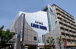 A modern hotel building with the name "HOTEL LIVE MAX" prominently displayed on its facade. - HOTEL LiVEMAX Esaka (Suita)