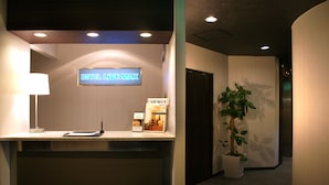 A hotel reception desk with a sign reading "HOTEL LIVE MAX" and a plant in the corner. - HOTEL LiVEMAX Shin-Osaka (Osaka)