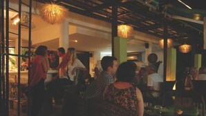 A crowded indoor space with people standing and sitting, possibly a restaurant or bar. - Cocooning Hotel (Koh Samui)
