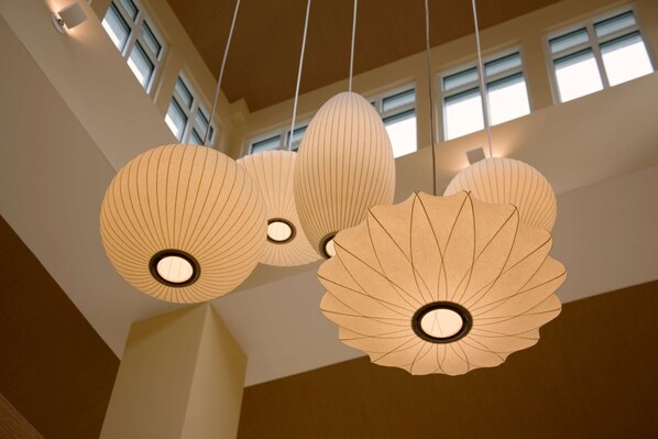 A ceiling with hanging paper lanterns and windows.