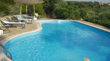 Seasonal outdoor pool, open 9:00 AM to 5:00 PM, pool umbrellas