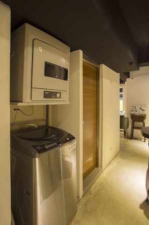 Guests can use the washer and dryer in this compact laundry room.