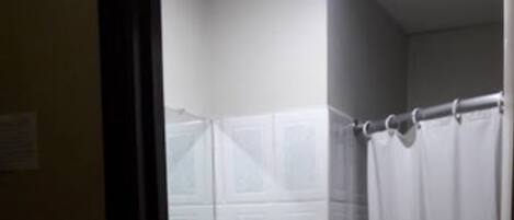 A bathroom with a white sink, a mirror, and a shower curtain.