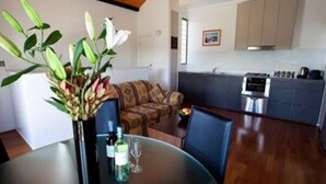 A modern kitchen with a dining area. - Harbourside Terraces (Wickham)