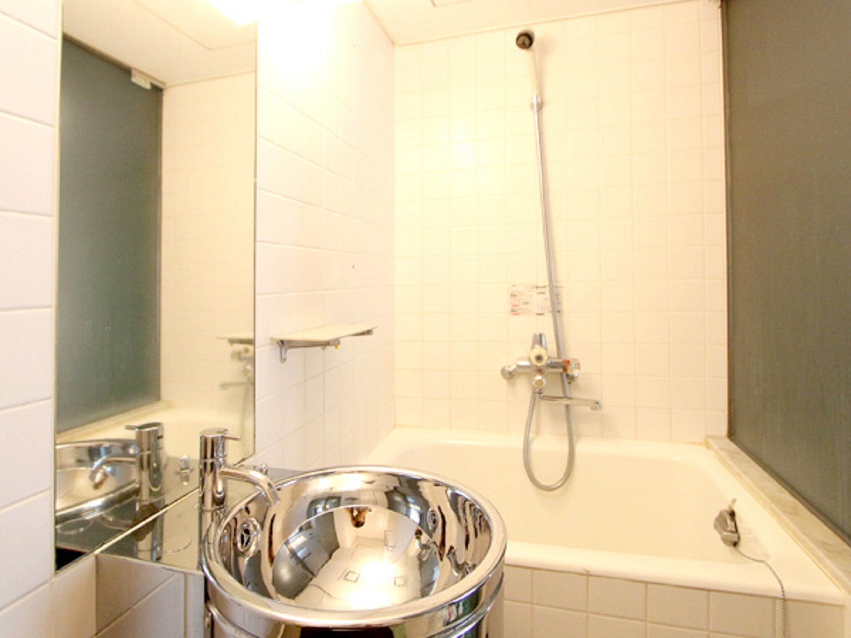 A bathroom with a bathtub, a shower, and a sink.