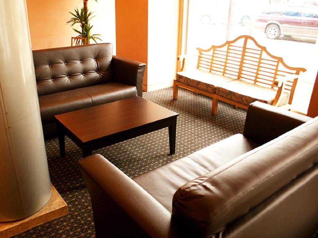 A seating area with a sofa, a coffee table, and a bench.