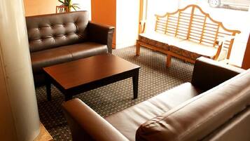 A seating area with a sofa, a coffee table, and a bench.