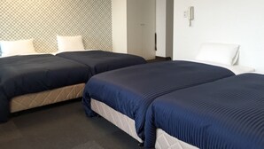 A hotel room with two beds, a patterned headboard, and a door leading to another room. - Hotel Livemax Budget Fuchu (Fuchu)