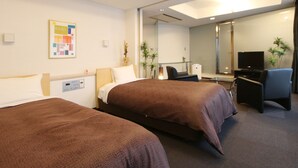 A hotel room with two beds, a desk, a chair, a TV, and a mirror. - HOTEL LiVEMAX Korakuen (Tokyo)
