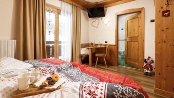 Relax in a comfortable room with a bed, bedside table, and desk, perfect for working or unwinding.