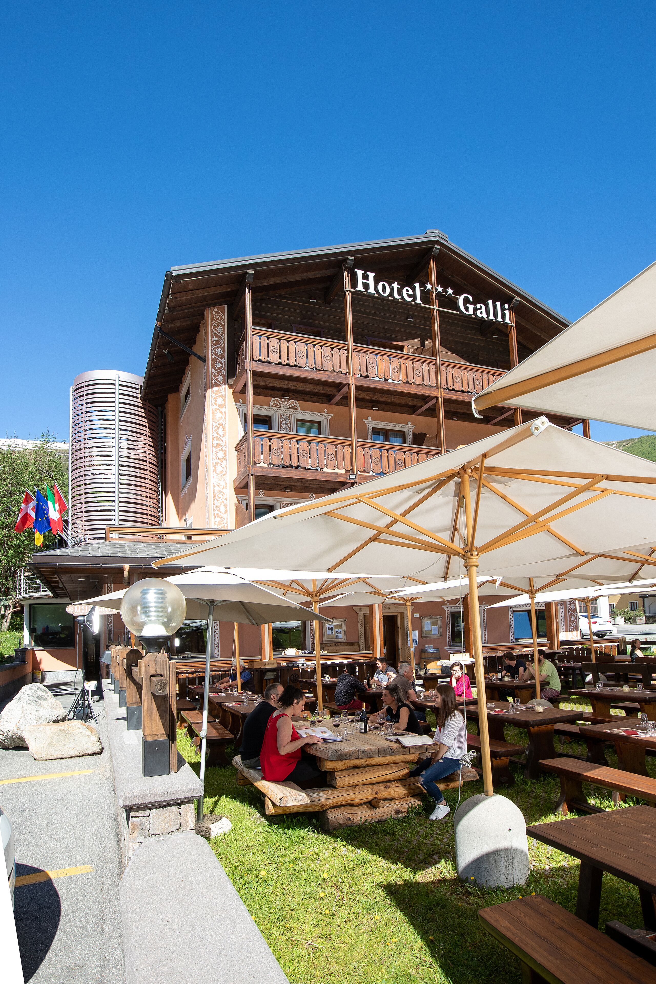 A wooden building with balconies and a sign that reads "Hotel Galli".