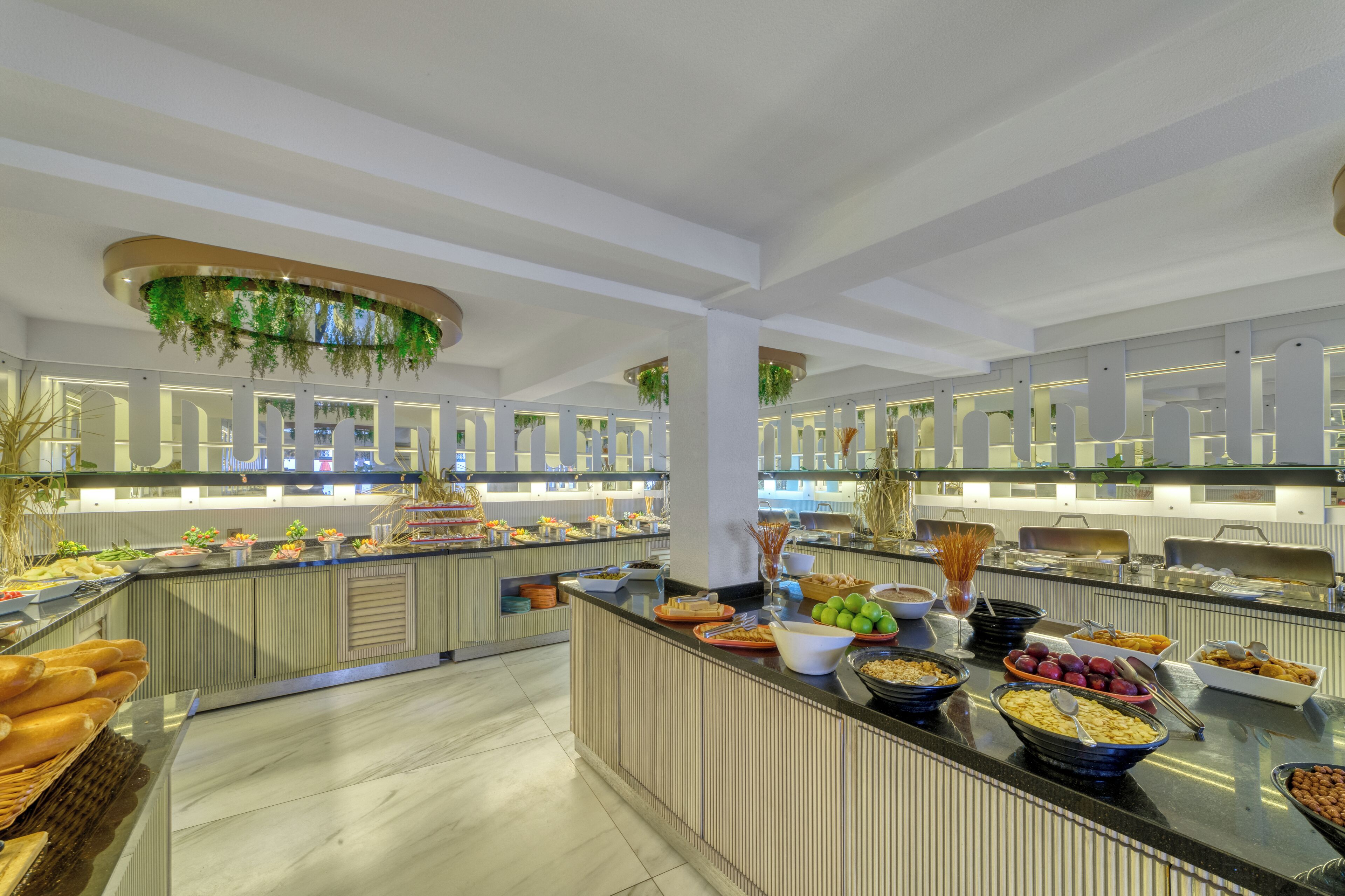 A buffet with various food items and a modern interior design.
