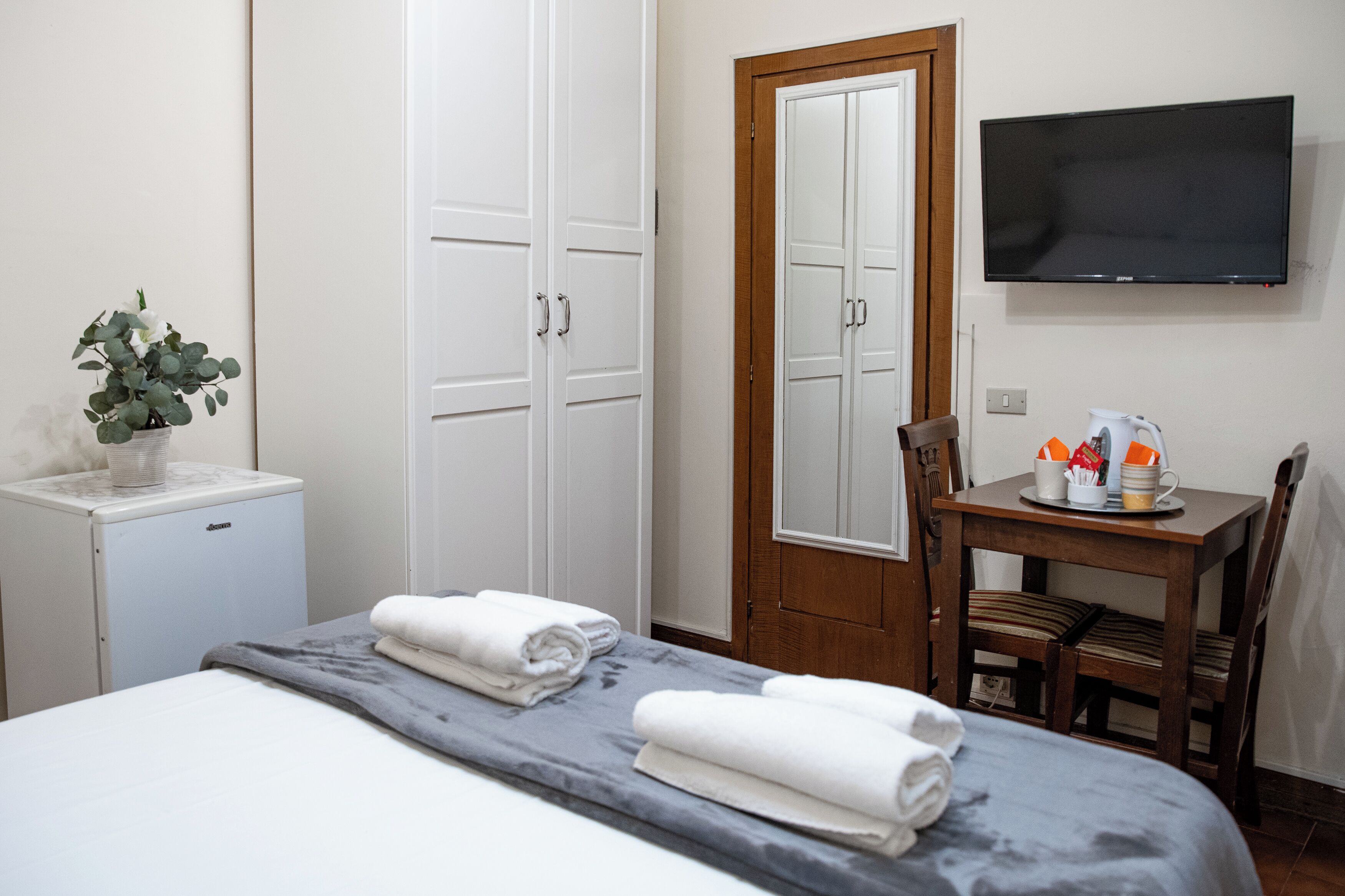 Basic Double Room, Private Bathroom (external) | Minibar, in-room safe, individually furnished, iron/ironing board