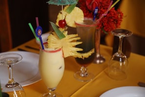 Enjoy a refreshing selection of drinks, served in a variety of glasses with tropical garnishes.