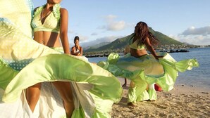 A beach scene with people in traditional costumes. - Oceanic Villa (Grand-Baie)