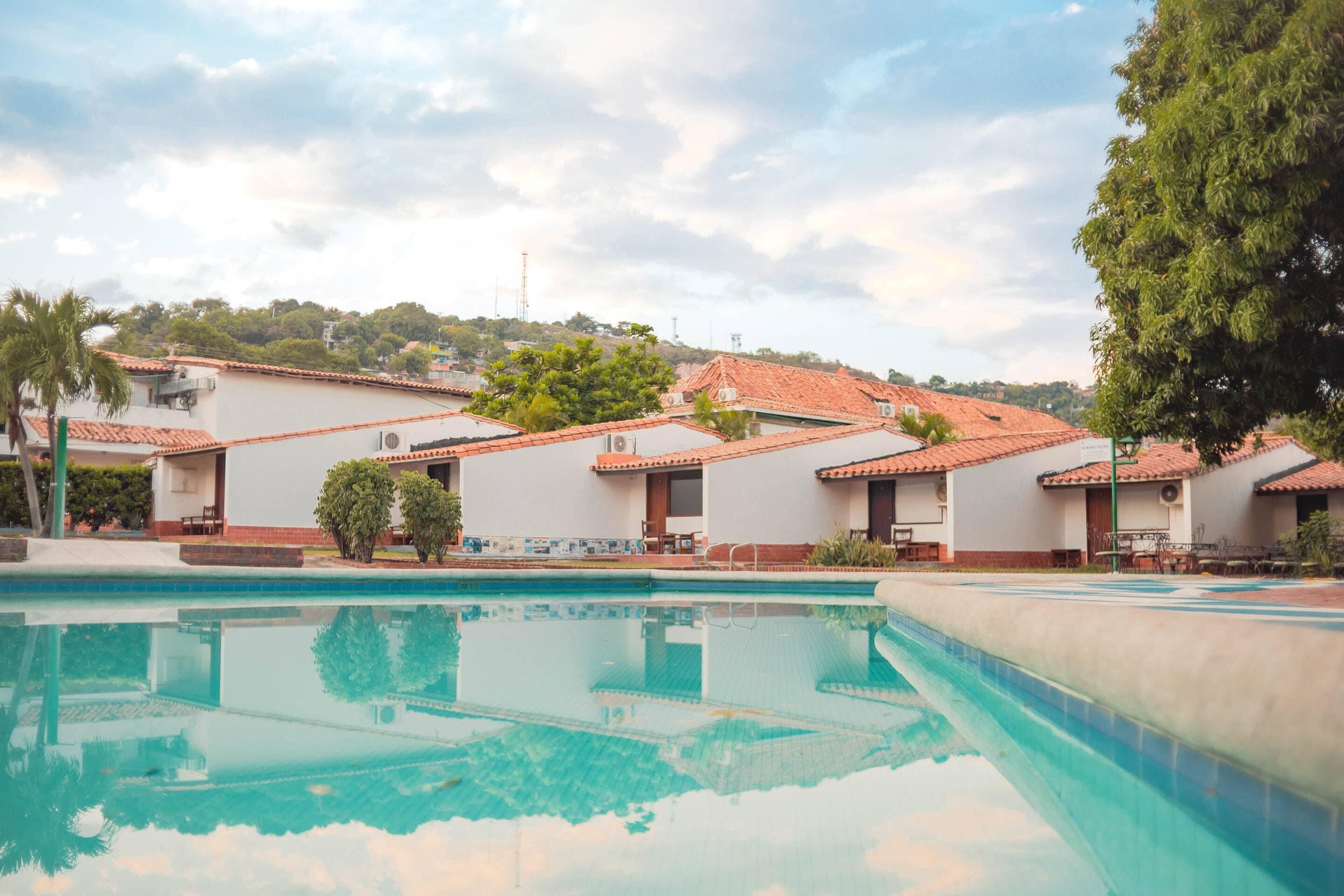 A swimming pool with a clear view of a residential area in the background.