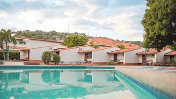 A swimming pool with a clear view of a residential area in the background.