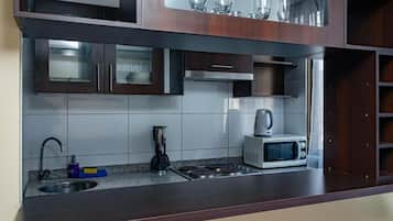 Family Apartment | Private kitchen | Microwave, toaster oven, cookware/dishes/utensils, dining tables