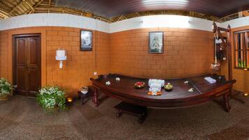 Enjoy a meal at a beautifully set table amidst framed artwork and lush greenery.