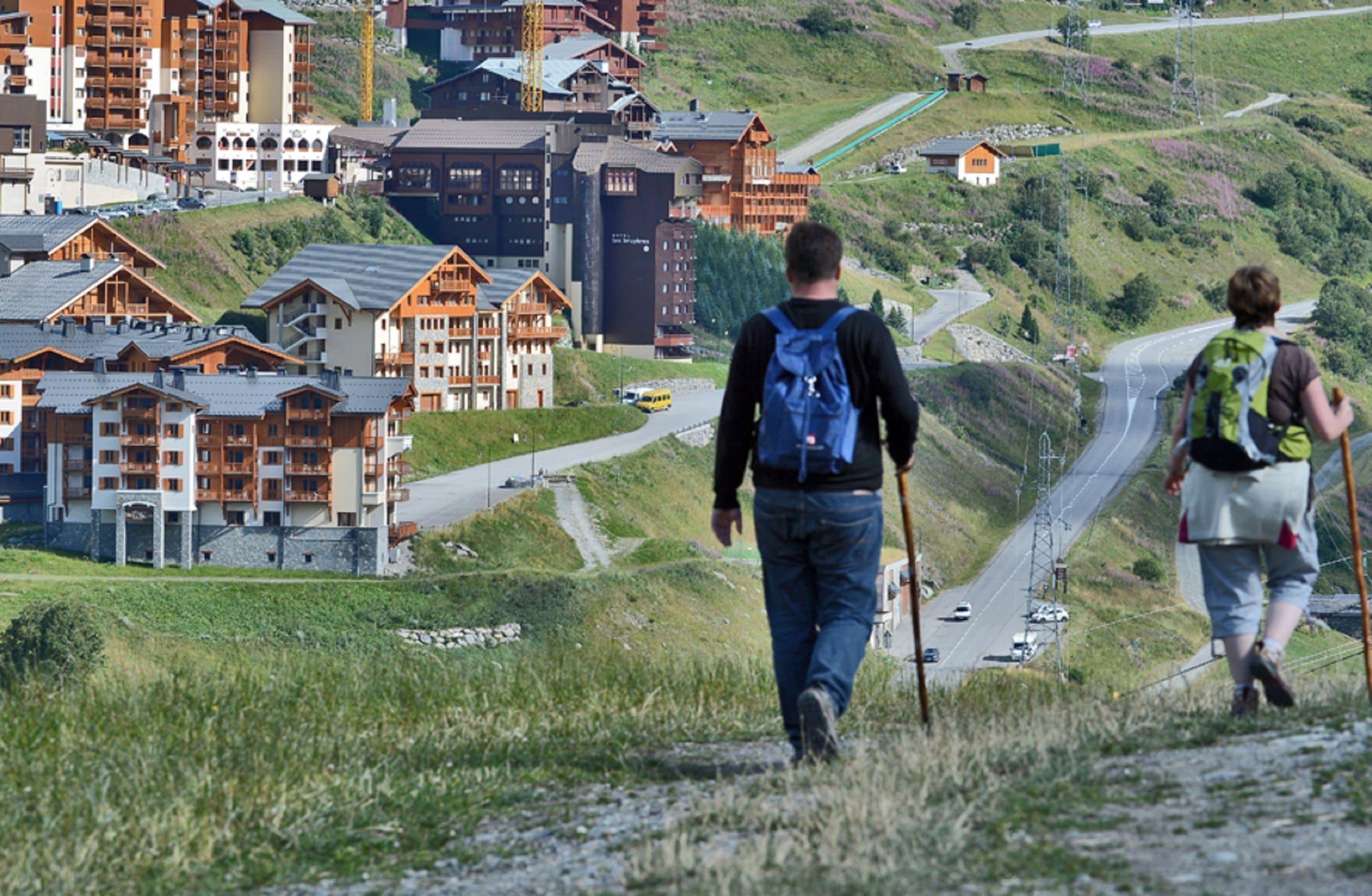 A mountainous area with wooden buildings and a road.
