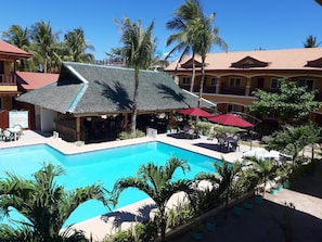 Relax by the pool surrounded by palm trees and enjoy the resort's tropical atmosphere.