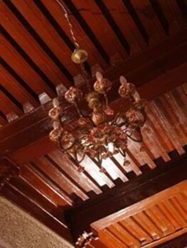 A wooden ceiling with a chandelier.