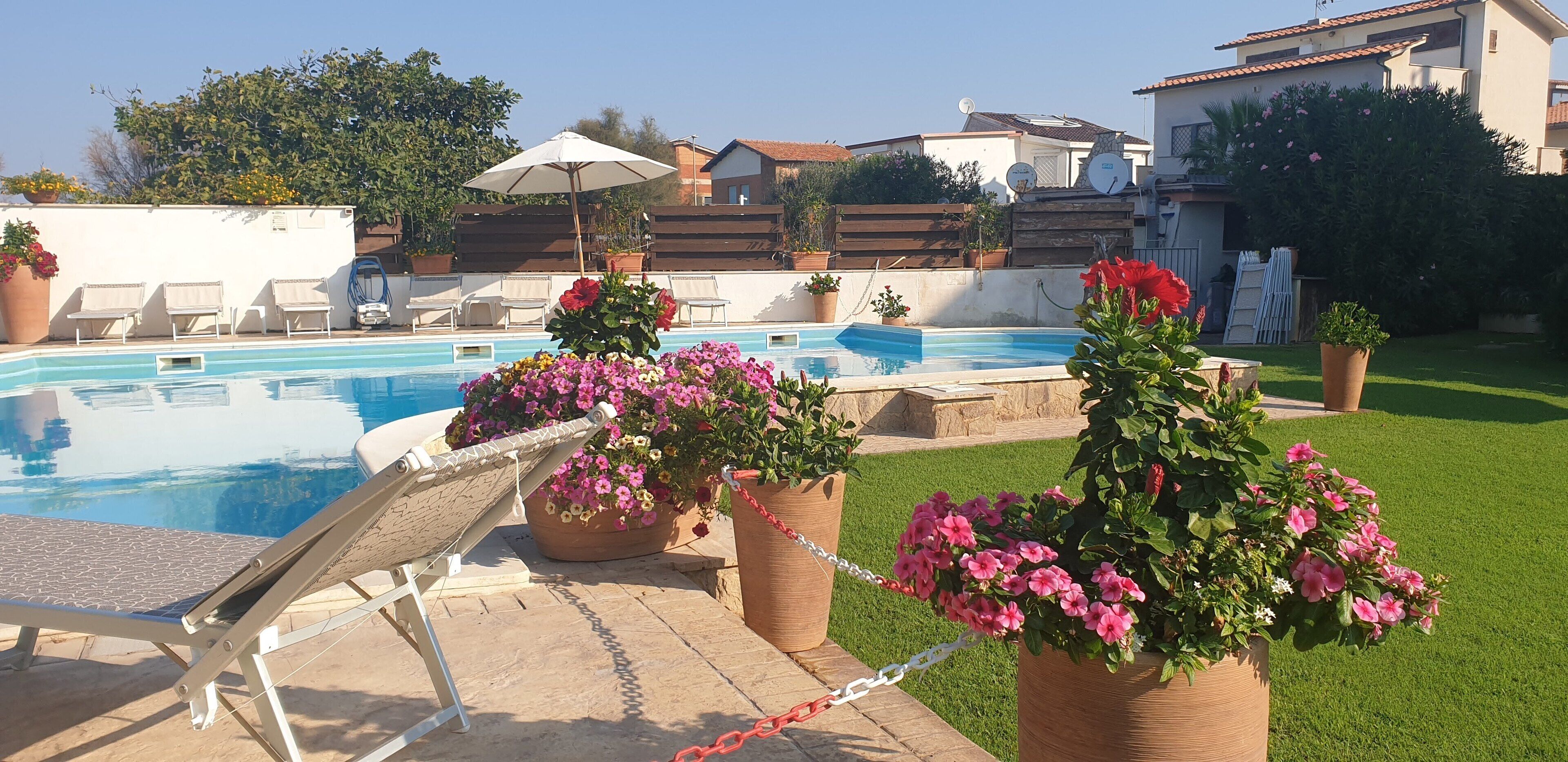 Seasonal outdoor pool, open 9:00 AM to 8:00 PM, pool umbrellas