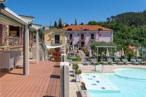 A hotel with a pool area, outdoor seating, and a view of the surrounding landscape. - Relais Il Casale (Tovo San Giacomo)