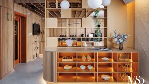 A modern reception area with a wooden reception desk, shelves with various items, and a wall-mounted TV.