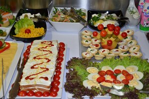 A buffet with various food items including salads, fruits, and appetizers. - Garni Hotel Zeder (Belgrade)