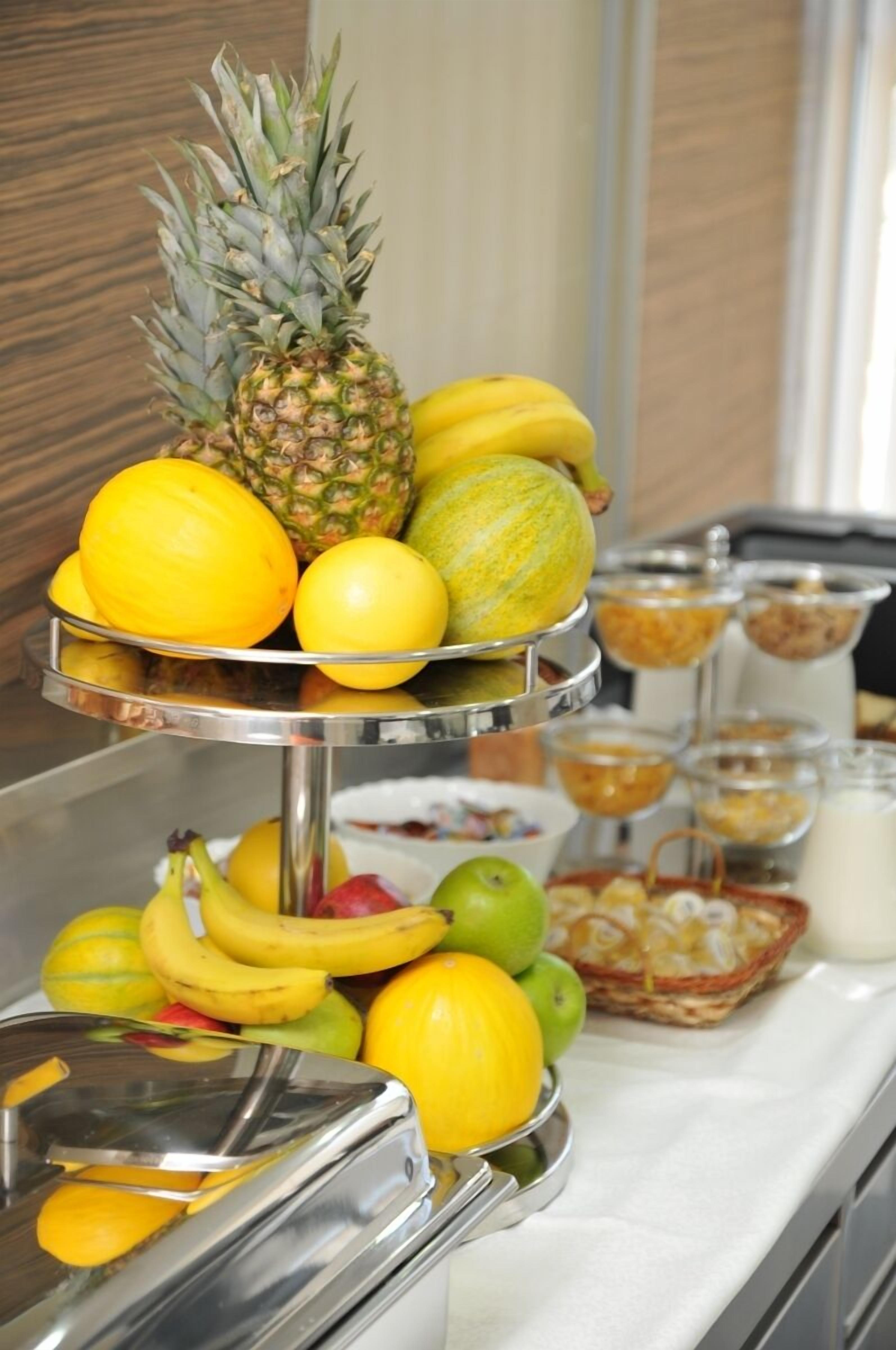 A buffet with various fruits and breakfast items.