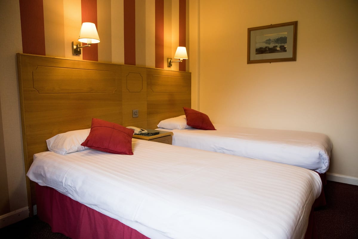 desk, iron/ironing board, bed sheets