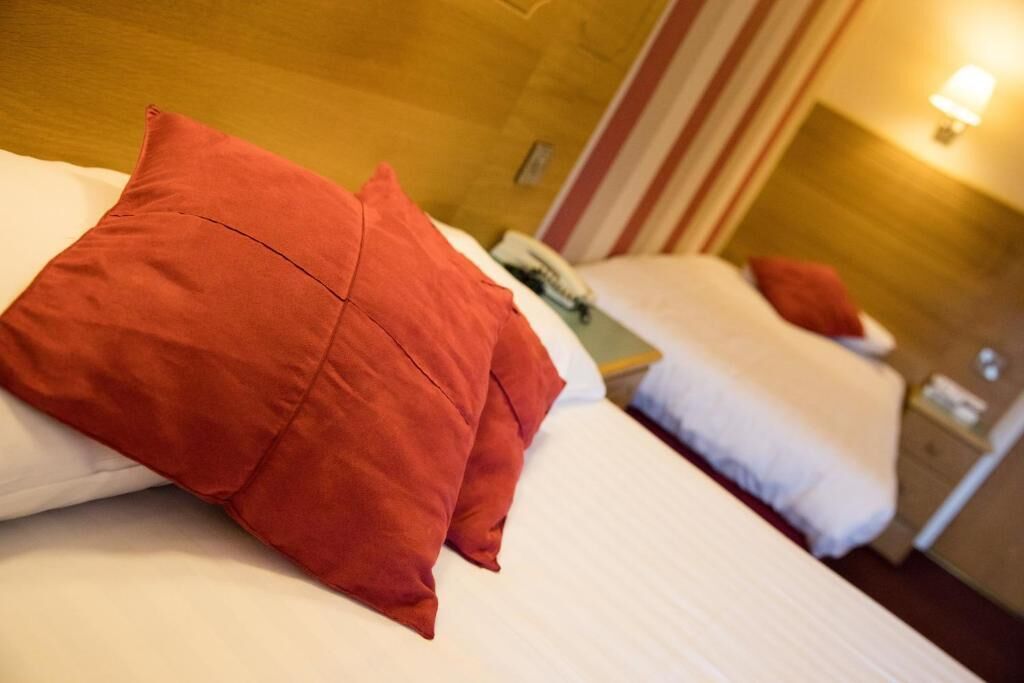 desk, iron/ironing board, bed sheets