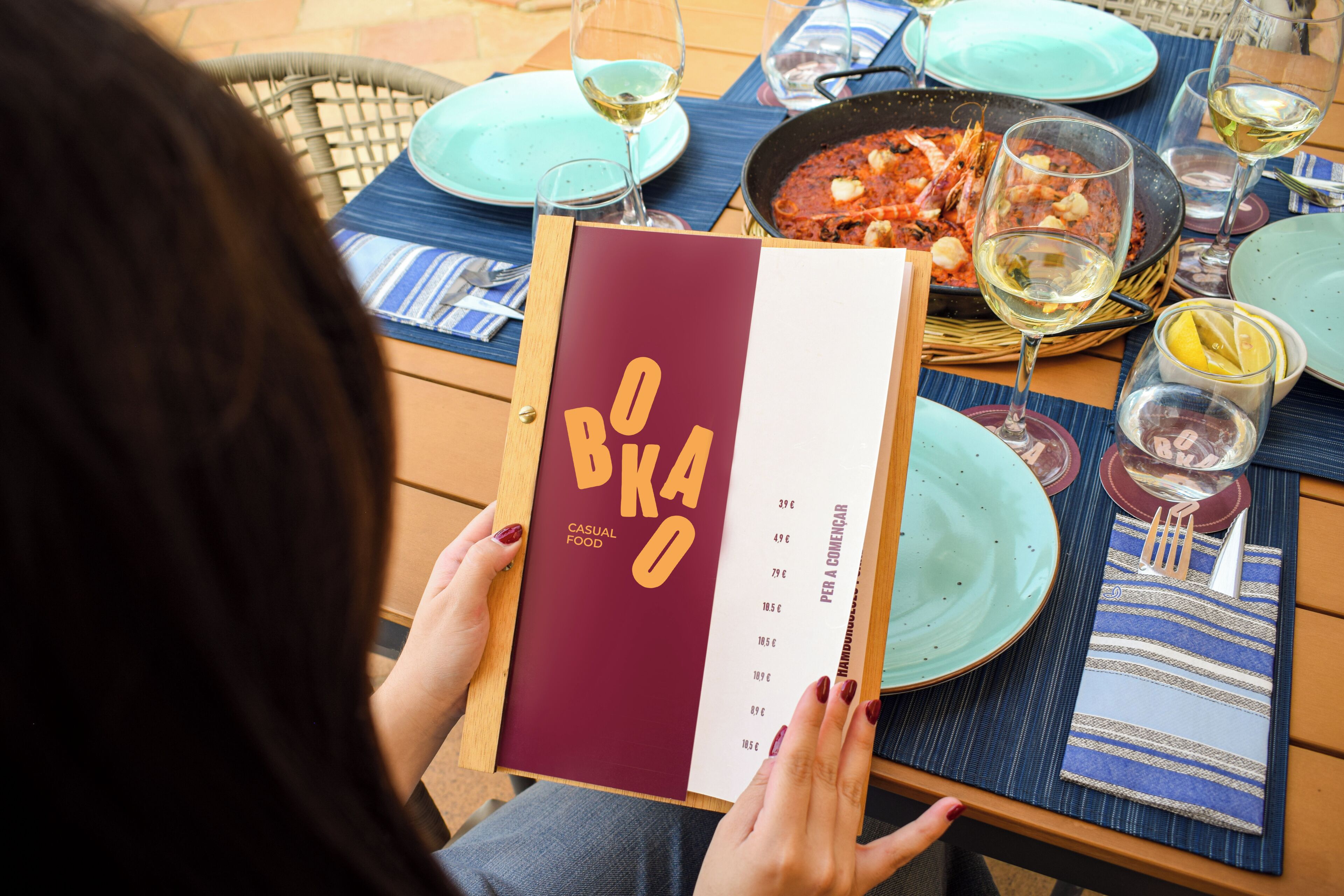 A person holding a menu with a list of food items and prices.