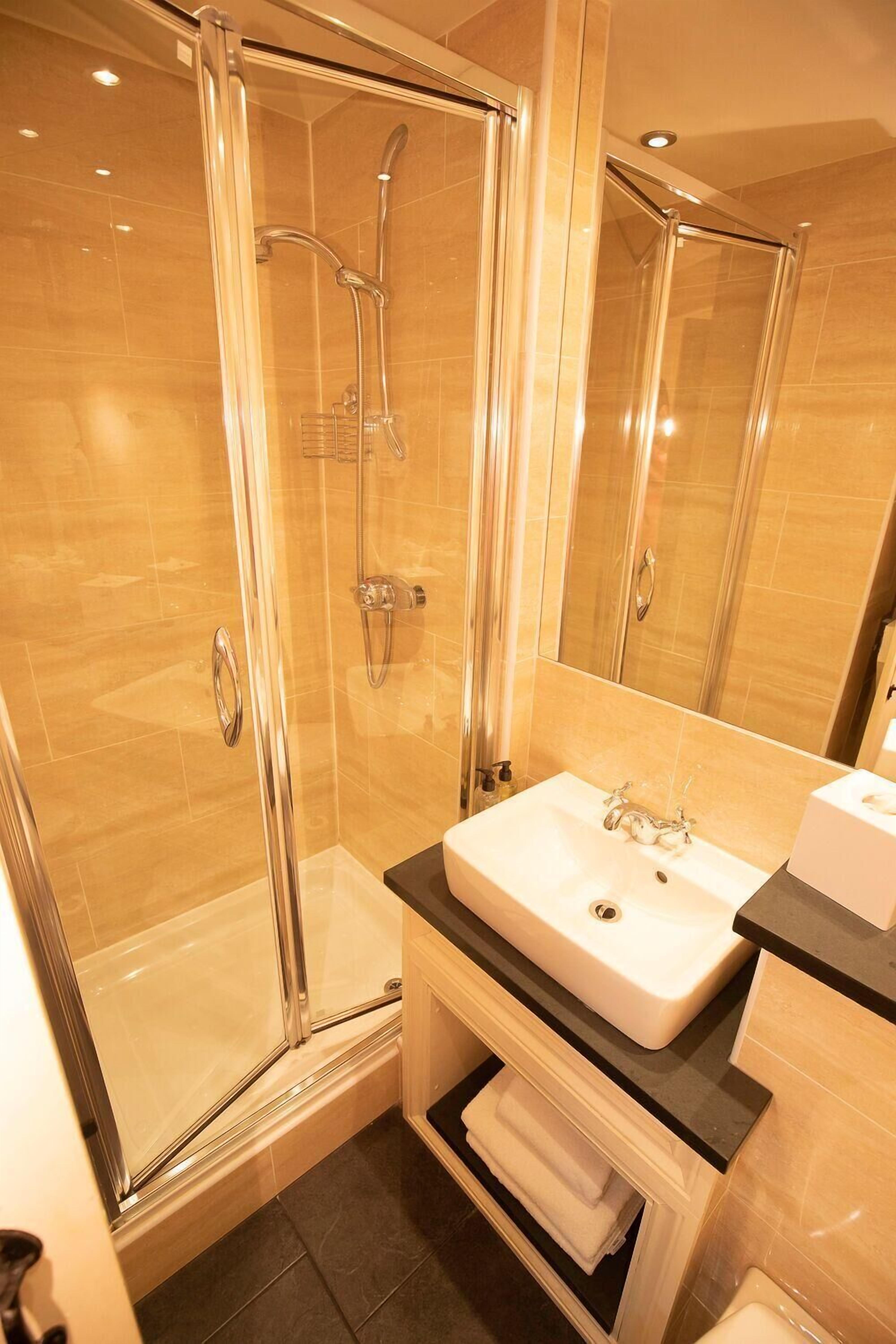 shower, rainfall showerhead, hair dryer, towels