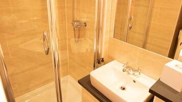 Shower, rainfall showerhead, hair dryer, towels
