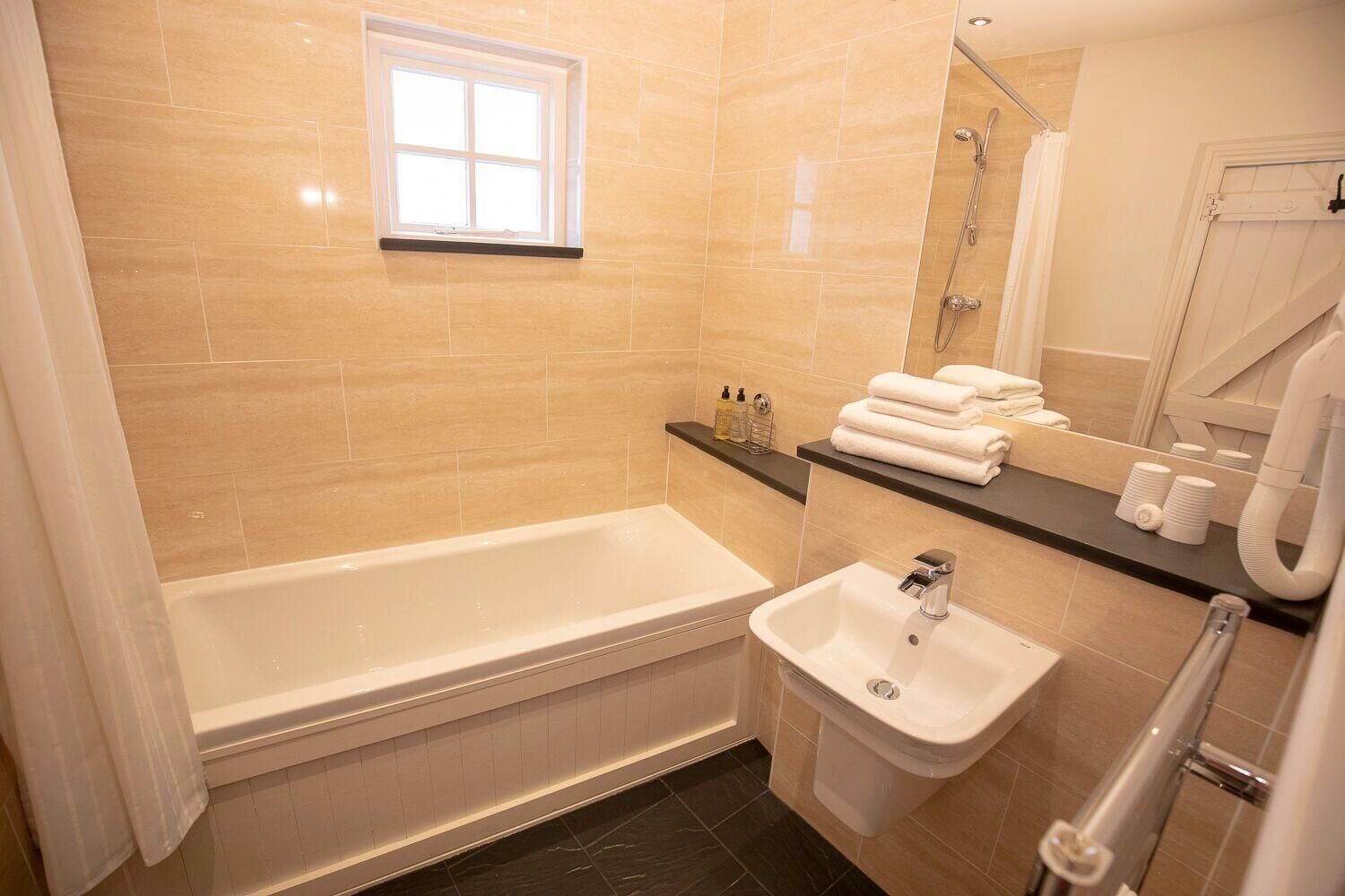 shower, rainfall showerhead, hair dryer, towels