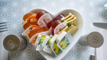 A heart-shaped bowl containing various food items and condiments.
