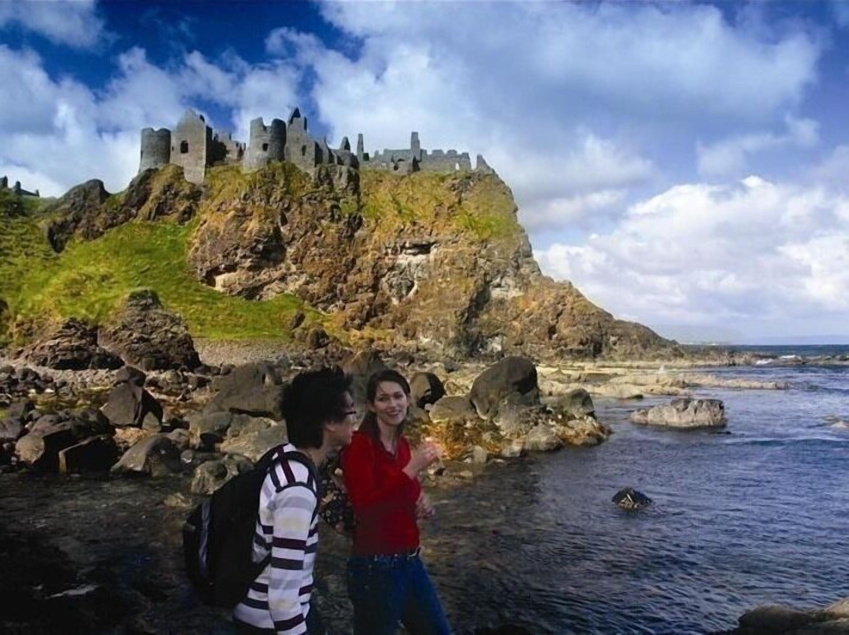 A castle on a rocky cliff overlooking the sea.
