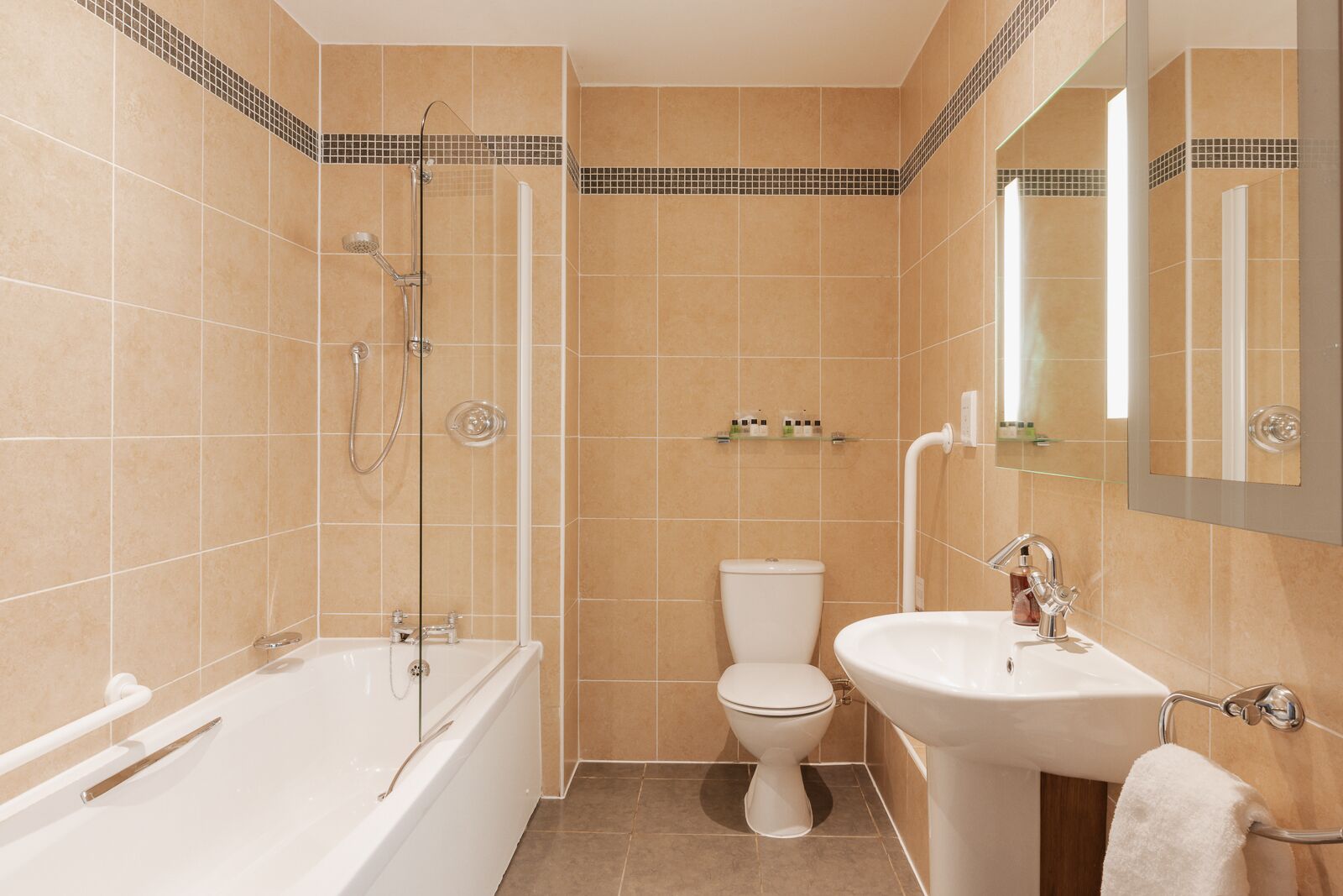 A bathroom with a bathtub, toilet, and sink.