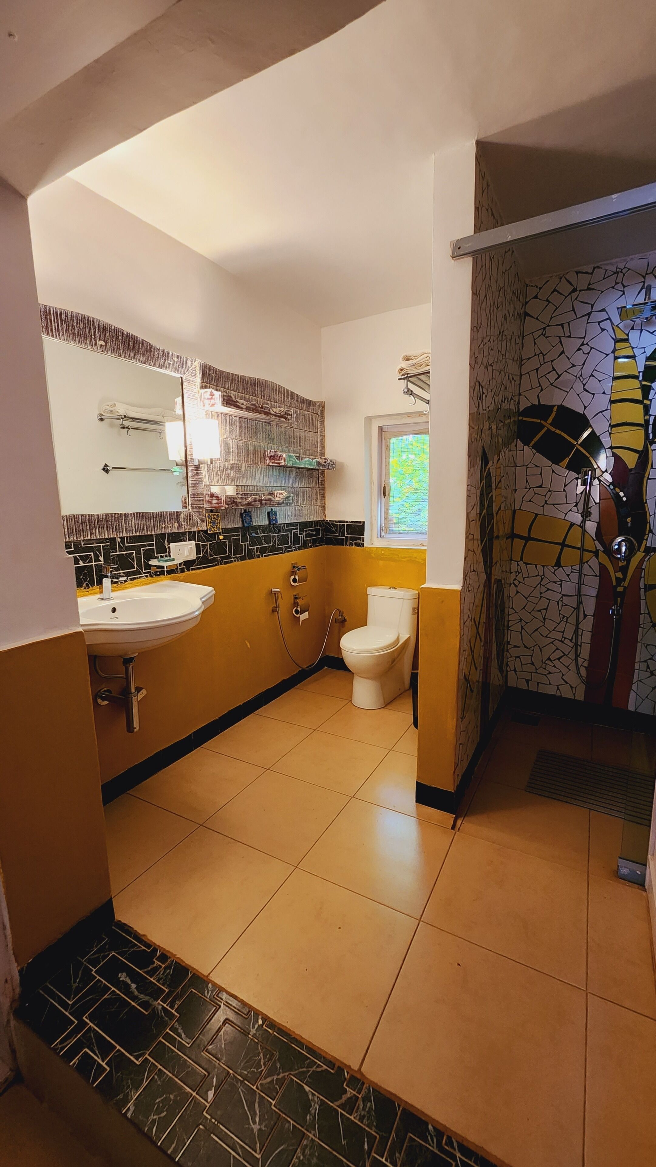 A bathroom with a sink, toilet, and a shower area.