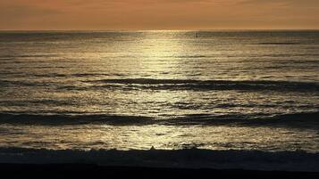 A sunset over a calm sea with a clear horizon.