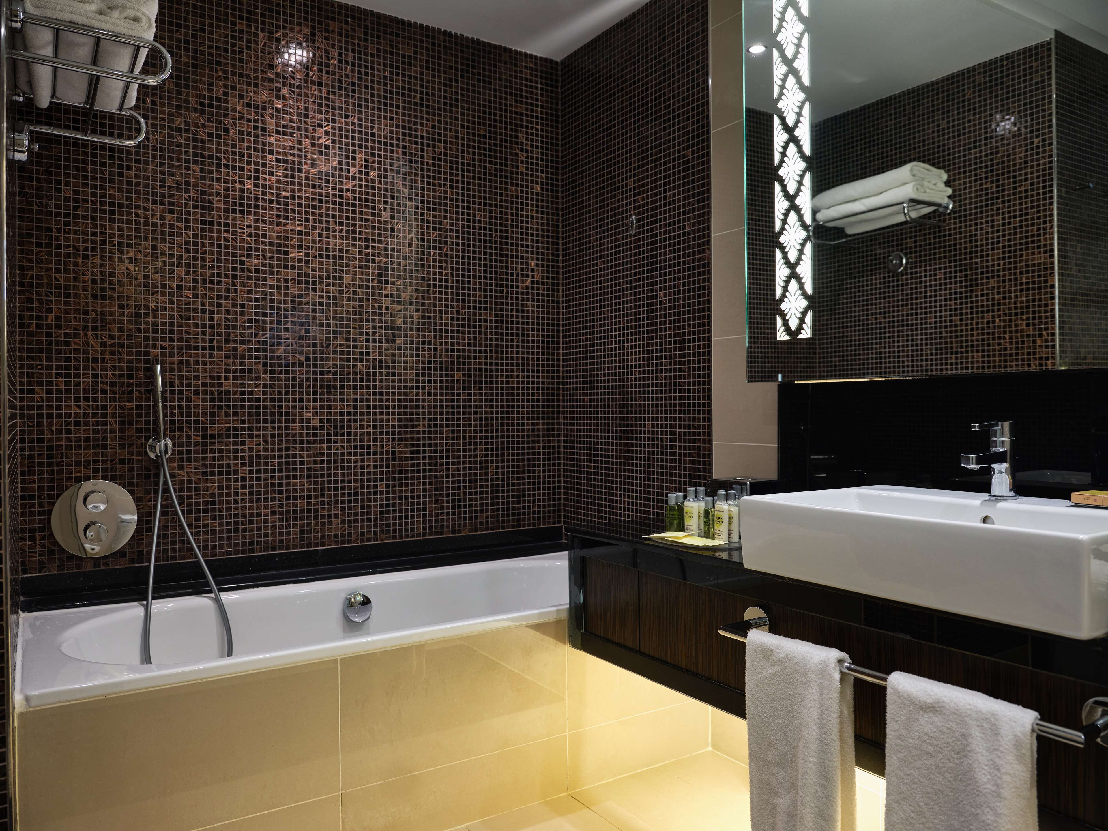 A modern bathroom with a bathtub, a sink, and a shower.