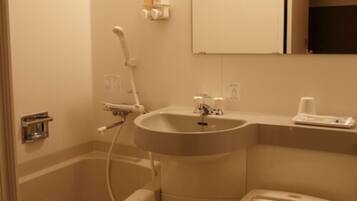 A bathroom with a sink, mirror, and toilet.