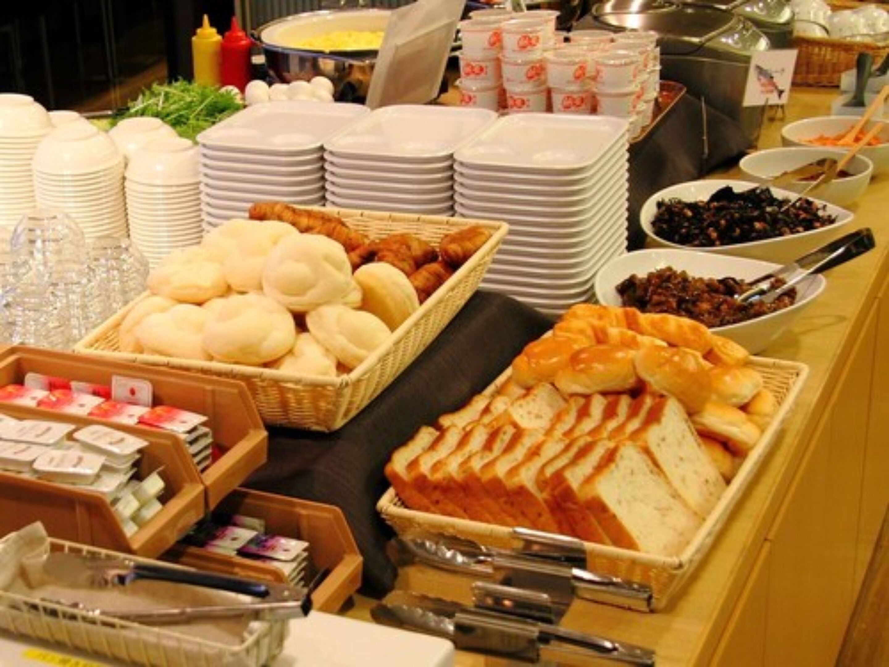 A buffet with various food items and serving utensils.