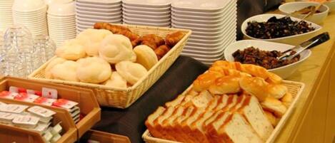 A buffet with various food items and serving utensils.
