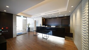 Una cocina moderna con armarios oscuros, una isla central e iluminación empotrada.
